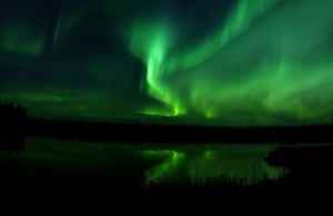 The_Aurora_Borealis_or_Northern_Lights_shine_above_Bear_Lake_in_Alaska_050910-F-MS415-009