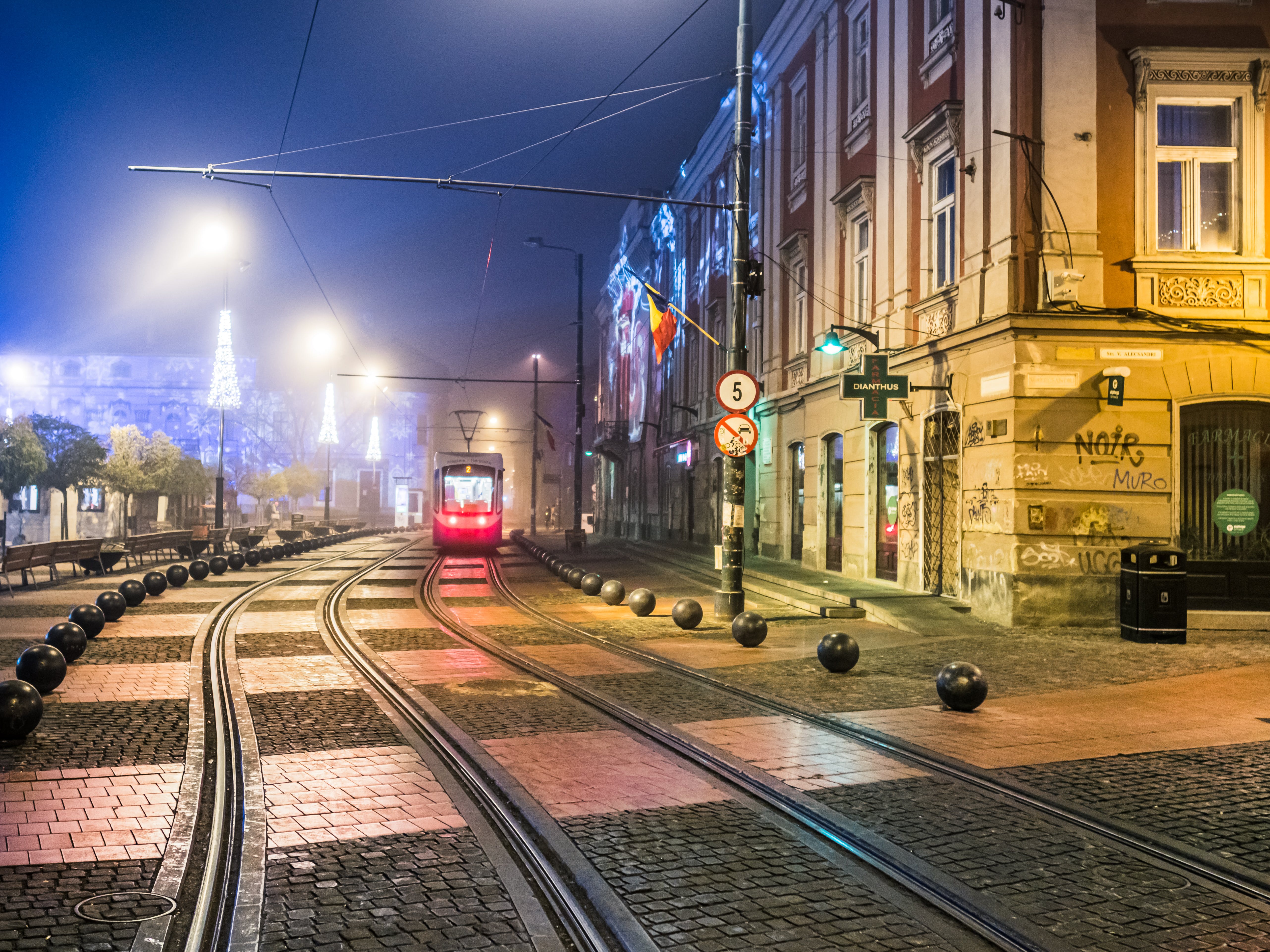 Red Train on Rail Road during Night Time